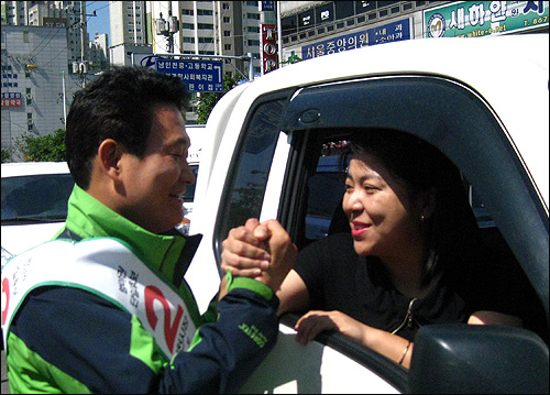 송영길 민주당 인천시장 후보가 1일 오전 유세 과정에서 만난 시민과 손을 맞잡고 승리를 기원하고 있다. 