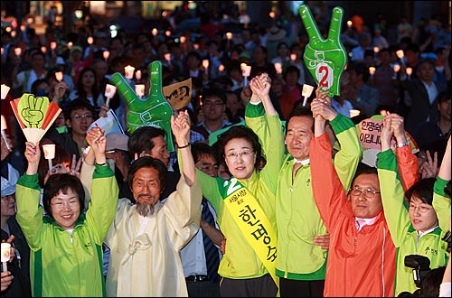  6.2 지방선거를 하루 앞둔 1일 저녁 서울 광화문 광장에서 열린 한명숙 민주당 서울시장 후보의 '생명과 평화를 위한 서울마당'에서 한 후보와 정세균 민주당 대표, 강기갑 민주노동당 대표를 비롯한 야당 지도부들이 시민들에게 지지를 호소하며 손을 들어보이고 있다.