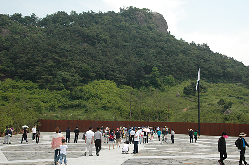 6.2 지방선거 이후 첫 주말을 맞아 김해 봉하마을 고 노무현 대통령 묘역을 찾는 참배객들이 부쩍 늘어났다. 사진은 봉화산 사자 바위 아래에 있는 묘역을 둘러보는 참배객들의 모습.