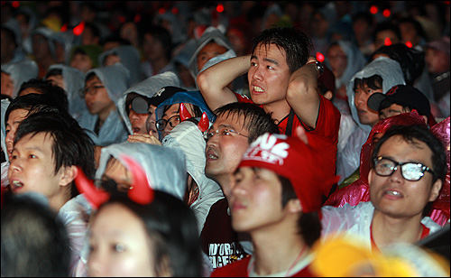  26일 밤 서울광장에서 열린 2010 남아공 월드컵 16강 한국과 우루과이와의 거리응원에서 전반전 우루과이 대표팀의 루이스 수아레스에 선제골을 허용하자 붉은악마들이 아쉬운 표정을 짓고 있다. 