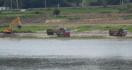 경기 여주의 여강(남한강)에 포크레인과 덤프트럭이 쉴새없이 강바닥의 
모래를 퍼나르고 있다.
