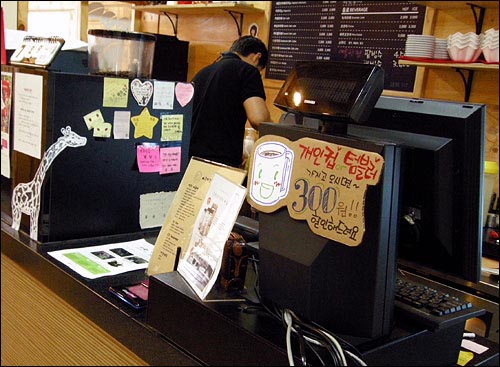 아름다운 커피 안국점 계산대 모니터에 '개인 텀블러 할인'을 알리는 안내판이 붙어있다.