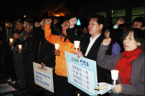  민주노동당에 후원금을 냈던 경남지역 교사들이 27일 저녁 경남도교육청 후문 앞에서 열린 집회에서 촛불을 들고 결의를 다지고 있다.