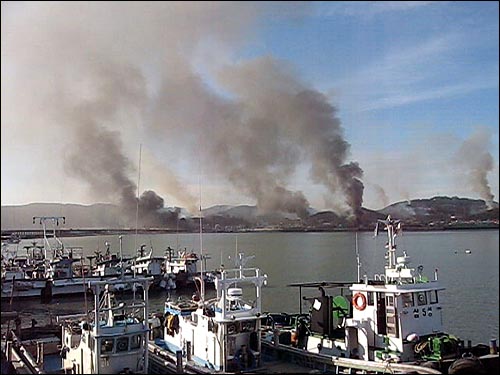 23일 오후 북한이 발사한 포탄이 연평도에 떨어져 폭발하면서 섬 곳곳에서 시커면 연기가 피어오르고 있다. 연평도를 방문한 한 시민이 제공한 화면.