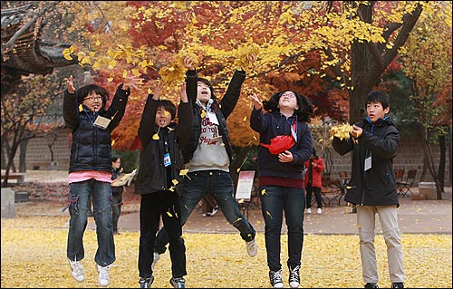 오마이뉴스가 주최하는 '제3회 나홀로 6학년들의 더불어 졸업여행'에 참석한 학생들이 24일 오후 서울 중구 덕수궁에서 낙엽을 던지며 즐거운 시간을 보내고 있다.