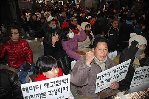  30일 저녁 부산 서면에서 열린 "예산안 날치기 전면 무효, 한진중공업 영도조선소 살리기 부산시민대회"에 참석한 시민들이 구호를 외치고 있다.