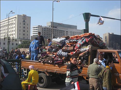 12일(현지 시각) 이집트 수도 카이로의 타흐리르 광장에서 일부 시위대가 농성 때 사용한 담요들을 걷어내고 있다.