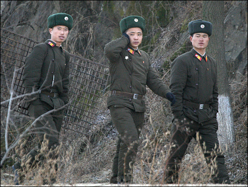 (AP=연합뉴스) 북한군 장병들이 2010년 11월 26일 북중 국경지대인 신의주 근처의 압록강 제방길을 따라 걷고 있다. 