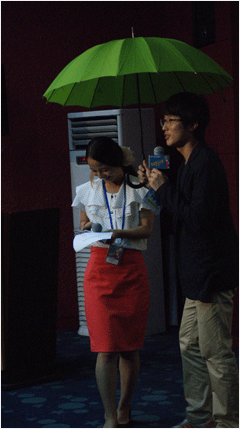 등장 퍼포먼스를 위해 파란 우산을 쓰고서 등장하고 있는 배우 임지규와 김꽃비.