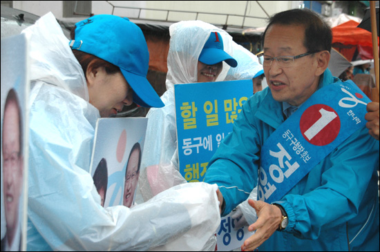  10.26 부산 동구청장 재선거에 나선 한나라당 정영석 후보가 22일 거리 유세 도중에 지지자들과 인사를 나누고 있다.