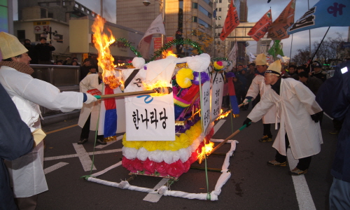한미FTA 반대 집회에 참가한 참가자들이 '근조 하나라당', '근조' 민주주의' 등이 새겨진 상여를 불태우고 있다.
