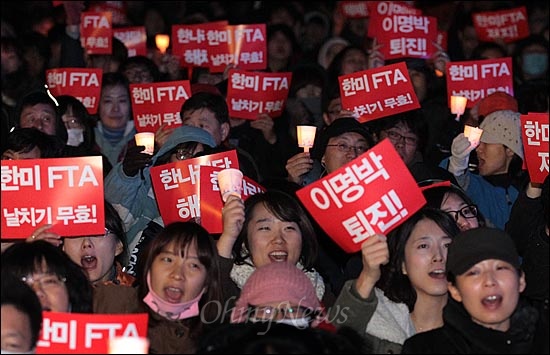 경찰이 광화문광장에서의 '한미FTA 날치기 무효 범국민 촛불대회'를 불허한 가운데, 3일 오후 서울 종로구 예금보험공사 앞에서 열린 '한미FTA 무효 야5당-범국본 합동연설회 및 범국민 촛불대회'에서 참가자들이 '한미FTA 날치기 무효'와 '이명박 퇴진' 등을 요구하며 구호를 외치고 있다.