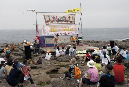  < Jam Docu 강정 >의 한 장면. 구럼비 바위에서 집회 중인 강정마을 주민들. 