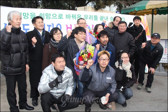 '희망버스'를 기획했던 송경동 시인과 정진우씨가 구속 87일만인 9일 보석 결정을 받고서 부산구치소에서 나온 뒤, 환영하러 온 사람들과 기념사진을 찍었다.