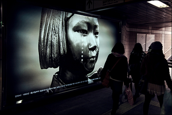 
서울 지하철 3호선 안국역 4번출구 안쪽에 '평화비'를 소재로 한 사진광고앞을 일본인 관광객들이 지나가가고 있다.