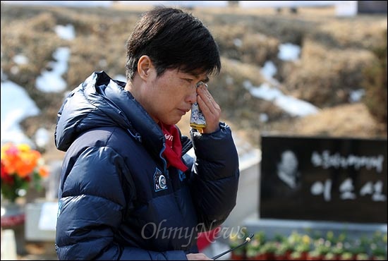  고 이소선 여사가 생전에 '희망버스'를 타고 만나고 싶어했지만 결국 만나지 못했던 김진숙씨가 묘역에 도착한 뒤 묘 가까이 가지 못한 채 돌아서 눈물을 흘리고 있다.