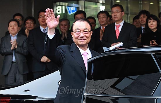 최시중 방송통신위원장이 22일 오후 서울 종로구 세종로 방송통신위원회에서 퇴임식을 마친 뒤 취재기자들에게 손을 흔들며 위원회를 떠나고 있다.