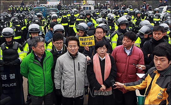 해군의 구럼비 폭파 강행을 앞둔 7일 오전 제주도 서귀포시 강정마을 해군기지 공사장 정문 앞에서 정동영 민주통합당 상임고문과 이정희 통합진보당 대표가 기자회견을 열고 해군기지 공사 중단과 백지화를 촉구하고 있다.