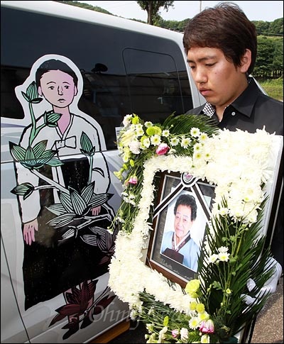 15일 오전 경기도 광주장례식장에서 일본군 위안부 피해자 고 김화선 할머니의 발인이 엄수된 가운데 박재홍 나눔의 집 간사가 영정사진을 모시고 있다.