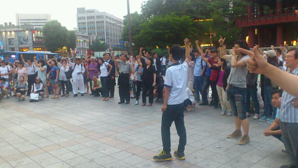 시민들이 김재철과 가위바위보 대결을 펼치고 있다