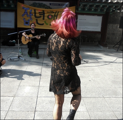 잡년행진의 한 참가자가 행진에 참여한 밴드 '소소한'의 음악에 맞추어 춤을 추고 있다.