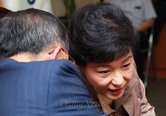 박근혜 새누리당 대선후보가 19일 오전 여의도 새누리당사에서 열린 정치쇄신특별위원회 회의에서 안대희 위원장의 귀엣말을 듣고 있다.