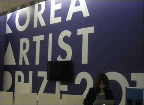  '올해의 작가전' 전시장 입구에 보이는 영문제목 'Korea Artist Prize 2012' 임민욱 작가(오른쪽)