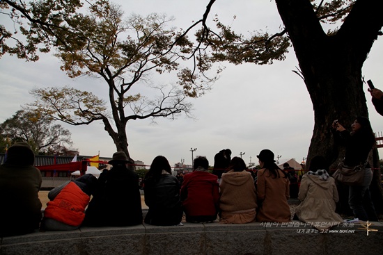 수원 화성행궁 앞에서 재연된 정조대왕 친위부대 장용영의 무예24기를 관람하고 있는 관광객들의 뒷모습이 정겹다.