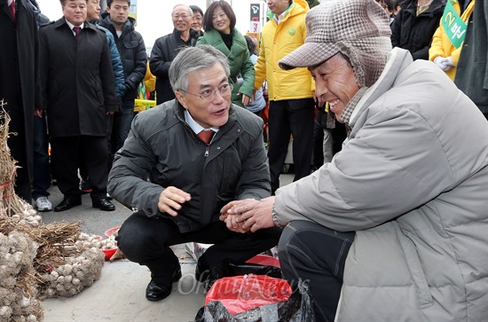  문재인 민주통합당 대선후보가 28일 대전 신탄진시장을 방문해 마늘을 파는 상인과 이야기를 나누고 있다.