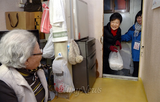 박근혜 대통령이 당선인 시절인 지난해 12월 25일 성탄절에 서울 창신동 쪽방촌을 방문해 직접 만든 도시락을 독거노인에게 전달하기 위해 방안으로 들어 서고 있다.
