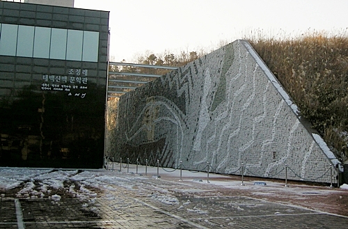 태백산맥 문학관 건물과 마주보고 있는 이종상 화백의 옹석벽화
