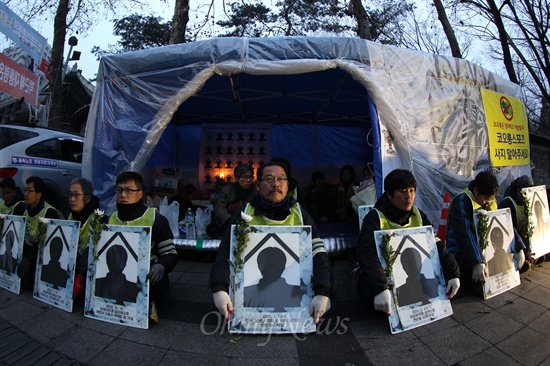 "강제철거 안돼!" 분향소 지키는 노동자들 3월 8일 오전 서울 중구청 철거반이 덕수궁 대한문앞 쌍용자동차 희생자 합동분향소를 강제철거할 예정인 가운데 영정을 든 동료노동자들이 분향소를 에워싸고 있다.