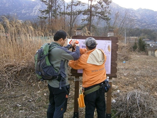 사진 왼쪽이 손성일 대장이고, 오른쪽이 필자다. 허리에 공구가방을 두르고 작업을 하고 있다. 계속된 작업에 지쳐서 그랬는지 뒷모습이 좀 '거시기'하다. 공구가방이 축 처져있다. 자켓에 달린 모자도 지퍼가 좀 풀려있다. 뒤에 있는 산은 영암 월출산이다. 