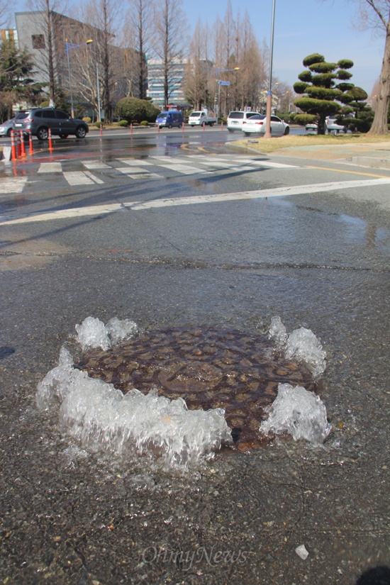25일 오전 경남 창원시 의창구 소재 경남도의회 앞 사거리 쪽 도로에 묻혀 있던 맨홀 뚜껑 사이로 물이 흘러 나왔다.