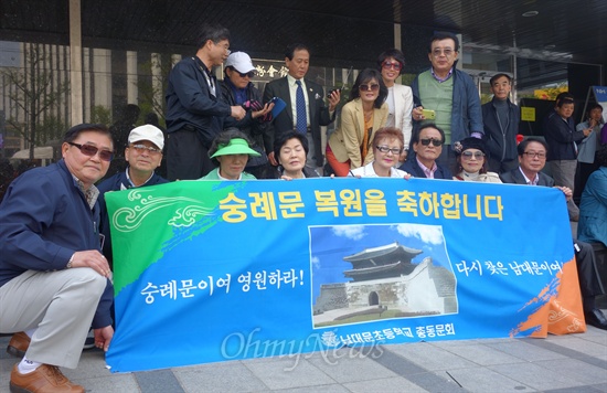 "우리 학교가 숭례문 바로 앞에 있었어요." 남대문초등학교 총동문회 회원들이 숭례문 복구를 축하하는 플래카드를 들고 있다.
