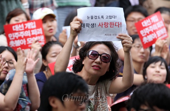 국정원 규탄 촛불집회 응원 "눈물겹도록 고맙다, 대학생"  국정원 대선 개입을 규탄하는 총학생회 시국선언과 종교계, 시민사회단체의 참여가 늘어나고 있는 가운데, 21일 오후 서울 종로구 광화문 KT 앞에서 열린 국정원 규탄 대학생 촛불문화제에 한 시민이 학생들의 촛불집회를 지지하며 '눈물겹도록 고맙다! 대학생! 사랑한다'라고 적힌 종이를 들어보이고 있다.