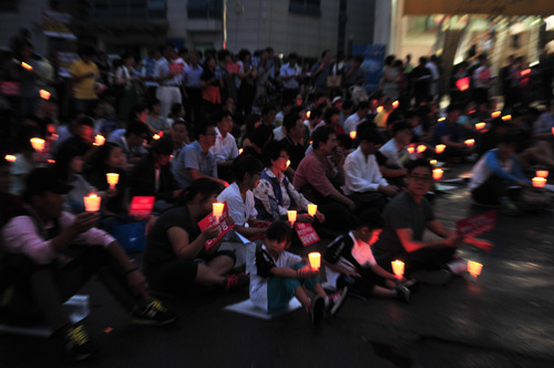 촛불과 피켓을 들고 함께 노래하는 시민들