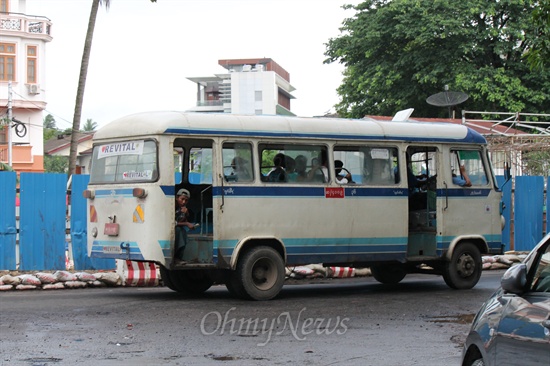 지난 6월 20일 미얀마 양곤의 도심 풍경. 미얀마 사람들은 버스를 주로 이용한다. 버스에는 안내원이 있어서 요금을 받는다. 점차 양곤에 차들은 느는데, 막상 도로는 패여 비가 내리면 물웅덩이가 곳곳에 만들어지기 일쑤. 곳곳에서 보수작업을 하고 있지만 그것만으로는 부족하다. 전체적인 도로 정비가 필요하다. 