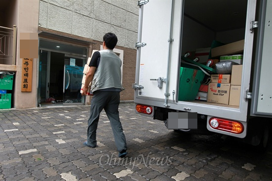 한 택배기사가 배달 물건을 옮기고 있는 모습. 택배기사 차들은 대부분 지입차이다. (자료사진)