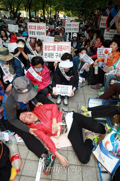 집회 도중 한 피해자가 탈진해 쓰러진 채 오열하고 있다.