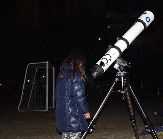 "진짜 잘 보여!" 한 학생이 망원경으로 100배 확대된 달을 보고 환호했다.