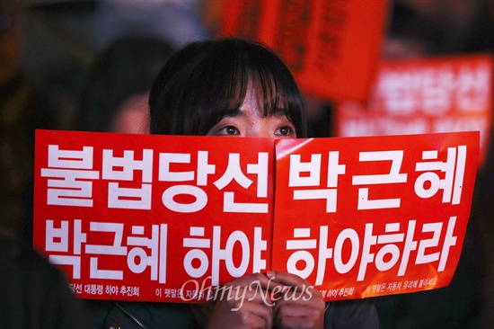 26일 오후 서울 용산구 서울역 앞에서 국정원 선거개입과 노동탄압을 규탄하는 촛불 집회에 참석한 시민들이 '박근혜 하야하라'고 적힌 피켓을 들고있다. 