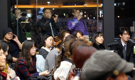 문재인 민주당 의원이 6일 오후 서울 마포구 한 카페에서 열린 팟캐스트 '최고 탁탁' 공개녹화 <응답하라 문재인>에 출연하자, 지나가던 시민들이 발걸음을 멈추고 창문 넘어 스마트폰으로 문 의원을 찍고 있다.