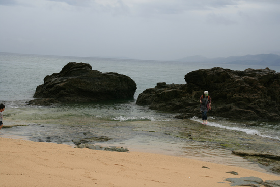 여행자들이 맑은 오키나와 바닷가를 즐기고 있다.
