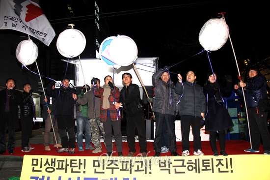 27일 저녁 창원 정우상가 앞에서 열린 "민생파탄, 민주파괴, 박근혜 퇴진 경남시국대회"에서 각 단체 대표들이 단상에 올라 '박 터뜨리기'를 하고 있다.