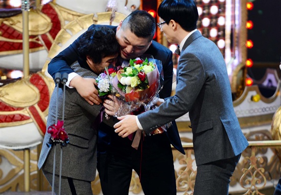  3년 간의 도전 끝에 김병만이 <2013 SBS 연예대상>에서 대상을 받았다. 함께 후보에 올랐던 강호동과 유재석이 김병만에게 축하 인사를 건네고 있다.