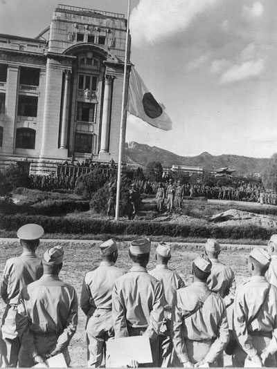 1945. 9. 9. 미군이 도열한 가운데 조선총독부 광장 국기 게양대의 일장기가 내려오고 있다. 이로써 일제강점기는 끝났다.