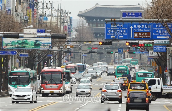 19일 오후 경기도 수원 장안문 앞 도로에서 많은 차량 사이로 경기도 버스가  운행되고 있다.