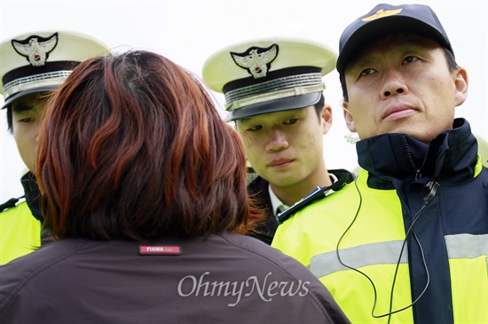 세월호 침몰사고 실종자 가족들이 20일 오전 1시 "청와대에 가겠다"고 도보 행진에 나선 가운데 경찰이 오후 7시께 진도대교를 2km 앞두고 이를 저지했다. 한 단원고 학부모가 경찰 앞에서 하소연을 하자 경찰이 안타까운 표정을 짓고 있다.
