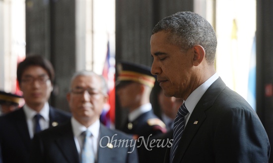 25일 방한한 버락 오바마 미국대통령이 서울 용산구 전쟁기념관을 찾아 UN참전국 전사자 명비에 헌화한 후 묵념을 하고 있다.